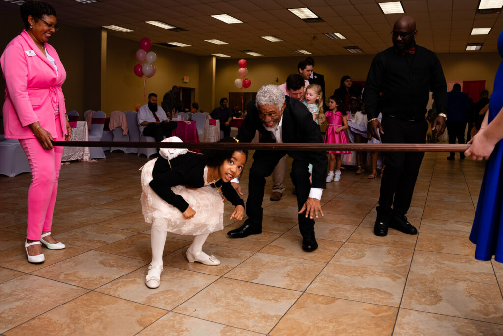Father and daughter dancing at a joyful event, capturing precious memories together.