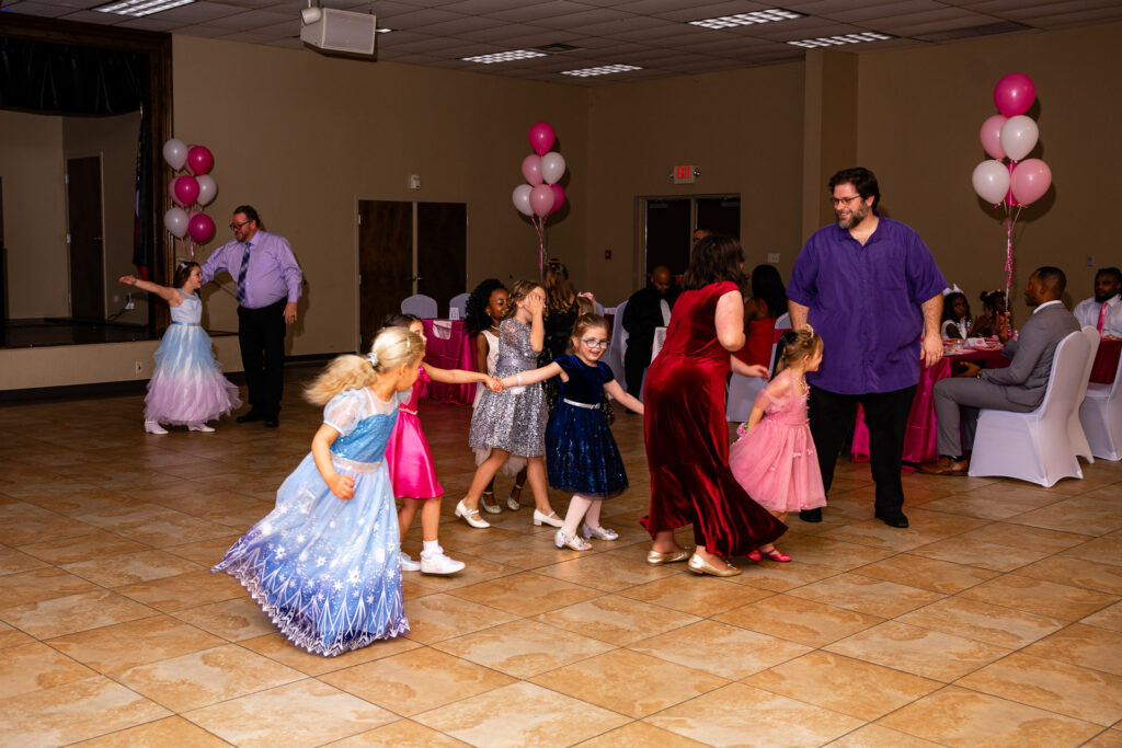 Father and daughter enjoying a heartfelt dance at a special event.