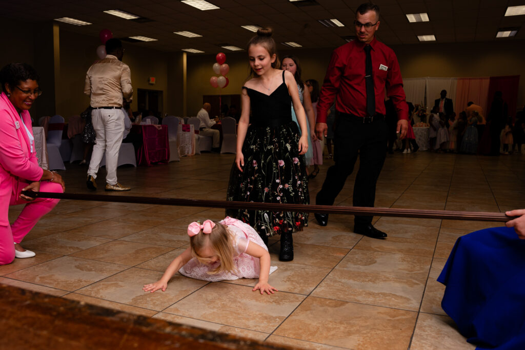 Heartwarming father-daughter dance moment captured at a joyful celebration event.
