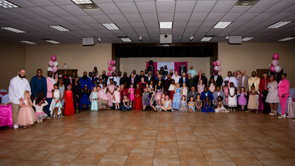 Heartwarming father-daughter dance moment captured at a joyful celebration event.