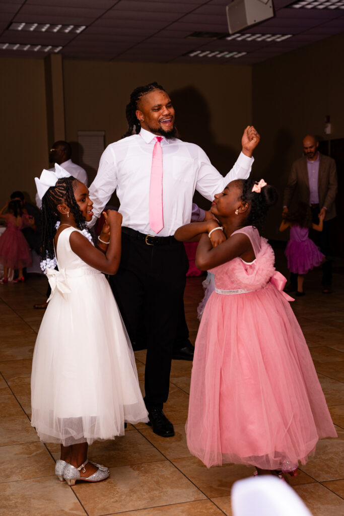Father and daughter share a joyful moment during their dance together at a special event.