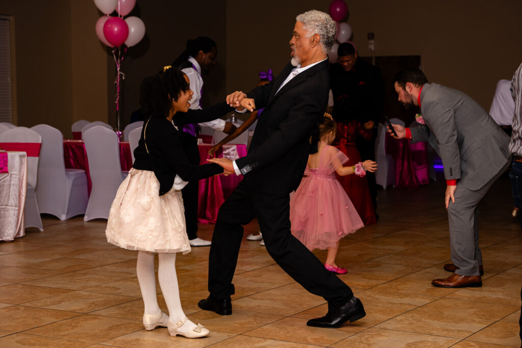 Father and daughter enjoying a special dance moment at a memorable event.