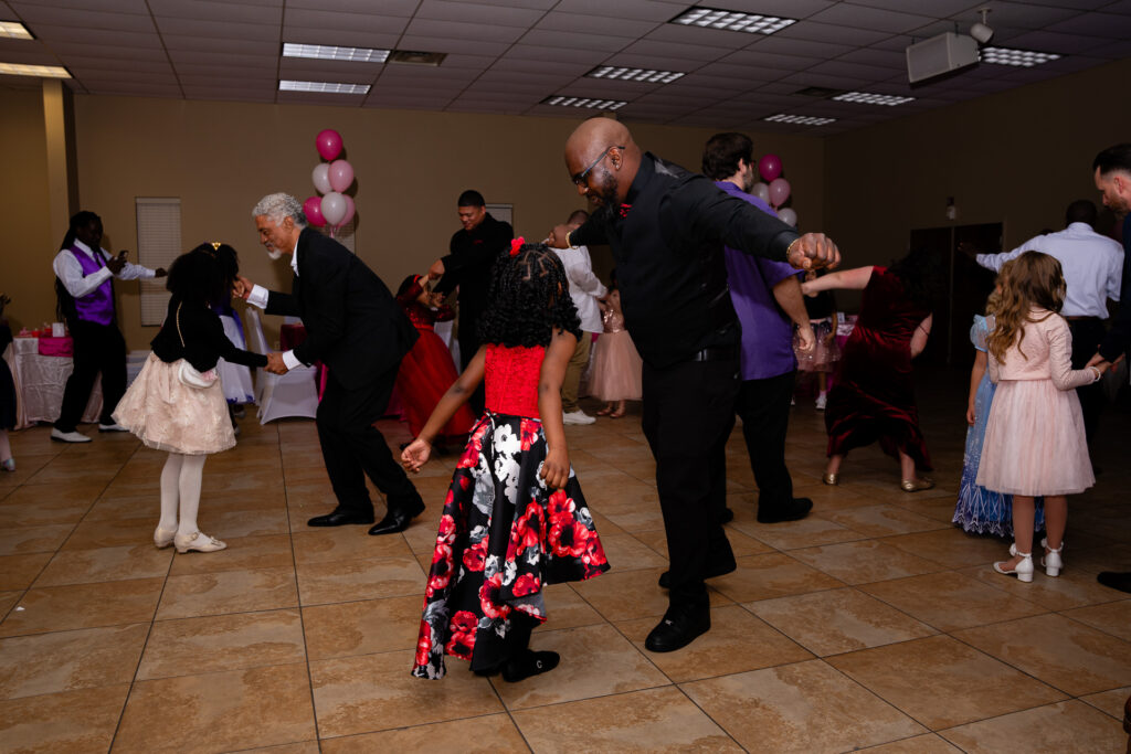 Father and daughter dancing together, celebrating their special bond at a memorable event.